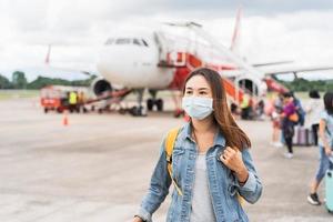 Young woman wearing a face mask at the airport, New normal lifestyle concept photo
