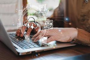 Businessman working and using laptop to access the cloud computing system, Internet Storage Networking and Cloud computing technology photo