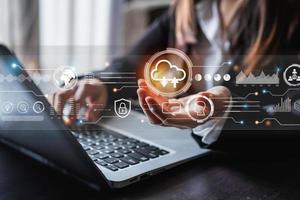Businesswoman working and using laptop to access the cloud computing system, Internet Storage Networking and Cloud computing technology photo