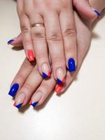 Acrylic nail extension, manicure, nail correction, hands in the foreground. Reflective design. photo