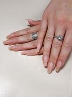 Acrylic nail extension, manicure, nail correction, hands in the foreground. Reflective design. photo