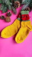 Knitted handmade items. Knitted fabric from colored thread. Bright background. photo
