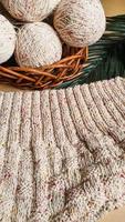 Knitted handmade items. Knitted fabric from colored thread. Bright background. photo