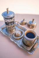 Turkish coffee with delight and traditional metal serving set photo
