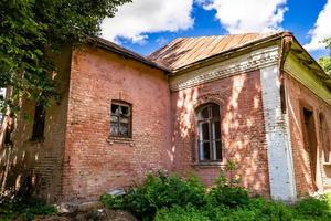 Beautiful old abandoned building farm house in countryside on natural background photo