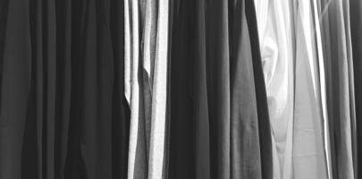 Art pattern of clothing, cotton or fabric hanging in line at fashion store in black and white style for background photo