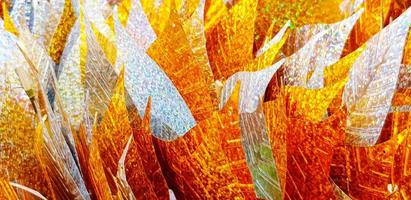 Close up silver and golden leaves for background at Thai temple. Group of object for respect holy, monk statue. Pattern of colorful leaf wallpaper photo