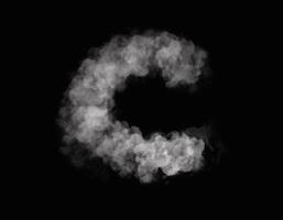 realistic smoke C alphabet spreading on dark background photo