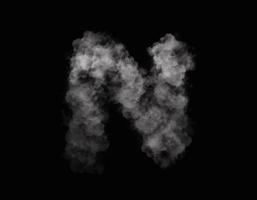 realistic smoke N alphabet spreading on dark background photo