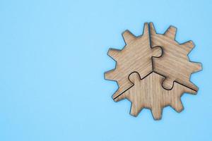 Wooden jigsaw puzzle on a blue background photo