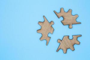 Wooden jigsaw puzzle on a blue background photo