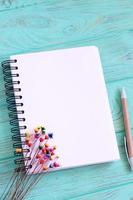 Open blank notebook on wooden table photo