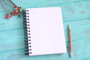 Open blank notebook on wooden table photo