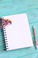 Open blank notebook on wooden table photo