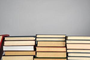 stack of different books on a gray background photo