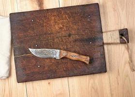 empty old wooden kitchen cutting board and knife photo