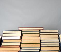 stack of different books on a gray background photo