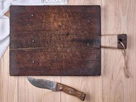 old wooden kitchen cutting board and knife photo