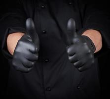 male chef in black uniform shows a gesture of approval photo