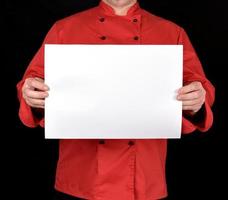 chef in a red uniform holding a blank white sheet photo