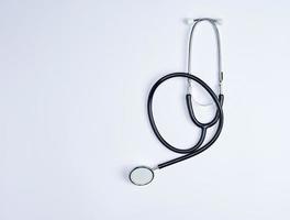 black medical stethoscope on a white background photo
