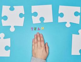 white big puzzles on a blue background,  inscription team photo