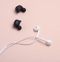 black wireless and white earphones with wire photo