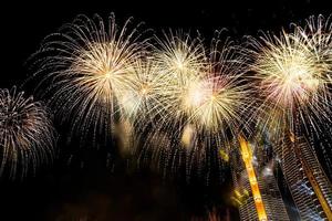 New year celebrate,  crowd and colorful fireworks near the river, Thailand photo