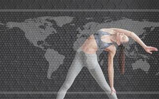 Digital world map on picture. Young woman with slim body shape in sportswear have fitness day indoors photo