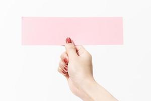 Close up women holding pink blank paper on white background. photo