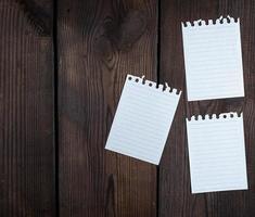 empty white sheets in a line torn out of notepad photo