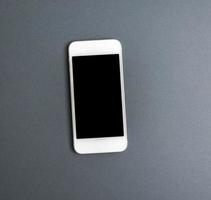 white smartphone with blank black screen photo