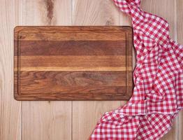 wooden kitchen cutting board and a red towel photo