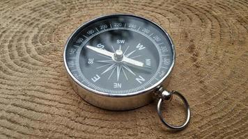 metal compass on the stump of the tree, close-up photo