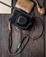 old vintage camera in a case on a wooden background photo