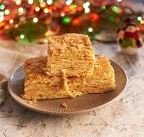 stack of slices of Napoleon cake made of puff pastry and butter cream photo