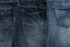several other classic jeans folded in a row photo