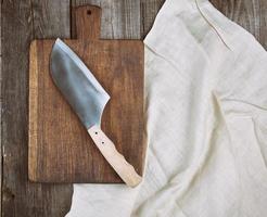 empty old brown wooden cutting board and knife photo