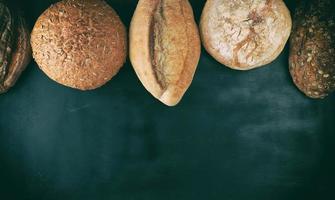 baked various loaves of bread on a black background photo