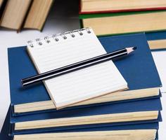 empty notebook with white sheets and a black pencil photo