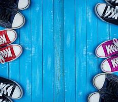 Youth colored sneakers on a blue background of the wooden planks photo