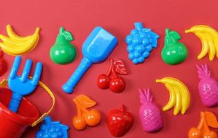 plastic childrens toys in the form of fruit and a bucket photo