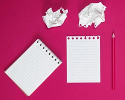 notebook with white sheets and a crumpled ripped out sheet of paper photo