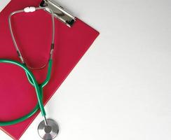 medical stethoscope and red paper holder
