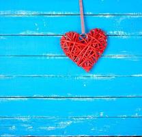 wicker red heart on a blue background photo