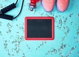 empty black chalk board and sporty pink sneakers photo