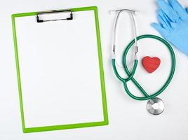 empty white sheets and medical stethoscope on a white background photo