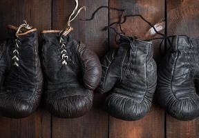 two pairs of leather old boxing gloves photo