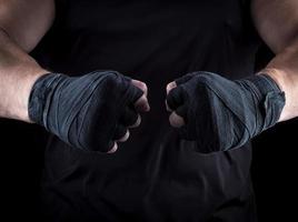 two men's hands wrapped in a black bandage photo