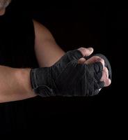 two men's hands wrapped in black sports textile bandage photo